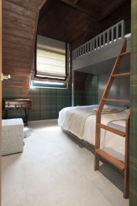 a bedroom with a bunk bed and a desk at Gigi Mountain Home in Divčibare