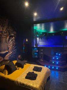 a room with a bed with a leopard head and a fireplace at Nyx suite d’exception in Dijon +10 photos