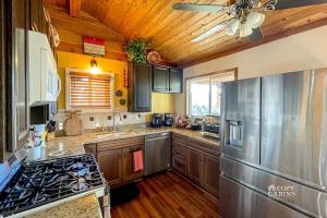 a kitchen with wooden cabinets and a stove top oven at Montana Vista in Ponderosa Heights