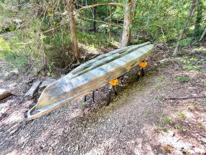 a surfboard sitting on a bench in the woods at Beaver Lake Luxury Retreat - Whispering Pines in Rambo Riviera +67 photos