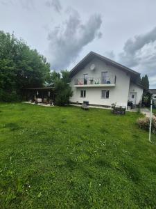 a house with a large yard with a grass field at Georgi in Freilassing