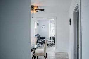 a living room with a table and a couch at Bright 3 BDRM Unit Perfect for Longer Stays in Windsor +7 photos