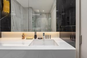 a bathroom with a white sink and a shower at Bellevue Lagoon Premium Apart Hotel by TropicLook in Laguna Phuket +77 photos