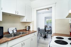 a kitchen with a sink and a stove top oven at Trendy 3 BedRoom Perfect for Long Stays! ! ! in Windsor