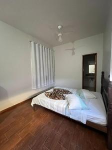 a bedroom with a bed with a leopard blanket on it at Hotel Sagrada Família in Montes Claros +2 photos