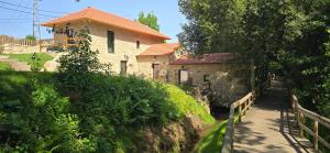 a house on a hill with a path next to it at Uíma River House in Lobão