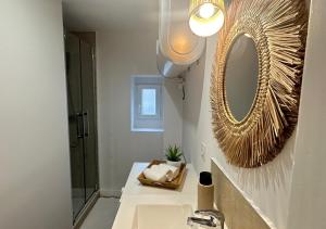 a bathroom with a sink and a mirror at Fleur Bohème - Hypercentre République - Parking in Le Mans +21 photos