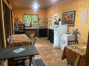 a kitchen with a table and a kitchen with a refrigerator at Nambí Rooms alojamiento no tradicional in Nambí