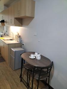 a small kitchen with a wooden table and a sink at Condominium Luxury 1 bedroom, impressive amenities in Davao City