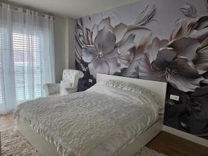 a bedroom with a large flower mural on the wall at Ático Monarca II in Arrecife +31 photos