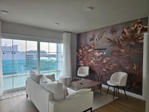 a living room with a large flower mural on the wall at Ático Monarca II in Arrecife