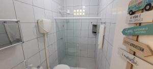 a small bathroom with a toilet and a mirror at Pousada Veruschka Santiago in Maragogi +29 photos