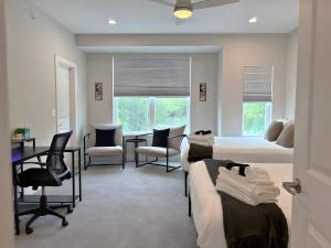 Un dormitorio con dos camas y sillas y un escritorio. en 4BR Townhouse with Lake View & Parking - Sleeps 10 - WV rep 3, en Warrenville 48 fotos más