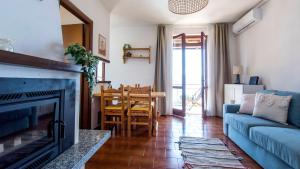 a living room with a blue couch and a table at Bellavista Riva Iseo in Riva di Solto