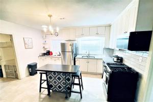 a kitchen with a table and a stove and a refrigerator at The great retreat - 1 mile from the University in Fayetteville