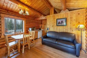 a living room with a couch and a table in a cabin at Togwotee Mountain Lodge in Moran