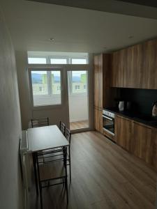 a kitchen with a table and chairs in a room at 3-izbový byt in Prievidza