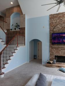a living room with a staircase and a fireplace at The Vibe in Conyers