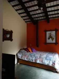a bedroom with a bed with a painting of a horse on the wall at Cabañas spa el petrel in San Javier
