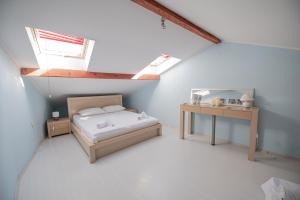 a attic bedroom with a bed and a table at Lake View, Old Town, Balcony, Family & Couples APT in Ohrid