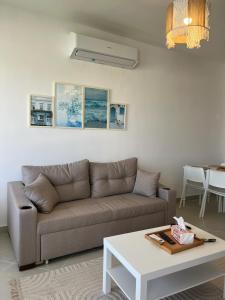 a living room with a couch and a table at 1BDR chalet on direct swimming pool Einbay in Ain Sokhna +20 photos