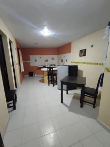 a room with a table and chairs and a kitchen at Las Villas Champoton in Champotón
