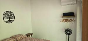 a room with a bed and a tree sticker on the wall at Sincorá Guesthouse in Lençóis