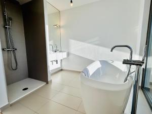 a white bathroom with a tub and a shower at Modern Stylish Luxury Apartment with Parking in Vienna +46 photos
