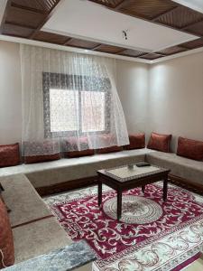 a living room with a couch and a table at Dar Boujida in Larache