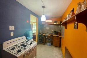 a kitchen with a stove and a sink in it at Isla Mujeres Punta Norte Private Bedroom 2 in Isla Mujeres