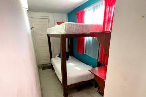 two bunk beds in a room with a window at Isla Mujeres Punta Norte Private Bedroom 3 in Isla Mujeres +3 photos