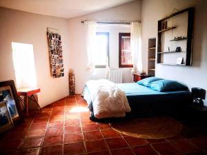 a bedroom with a bed and a tiled floor at Maison 3 chambres 170m2 in Pierrerue