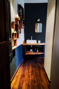 a bathroom with a sink and a wooden floor at Maison 3 chambres 170m2 in Pierrerue