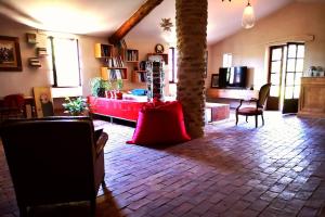 a living room with a palm tree in the middle of a room at Maison 3 chambres 170m2 in Pierrerue