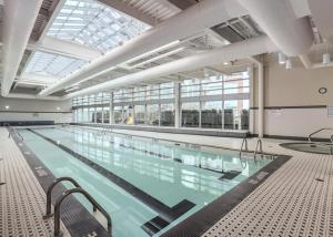 a large swimming pool in a large building at The Vancouver Penthouse, 2-Level, Patios, Hot Tub in Vancouver