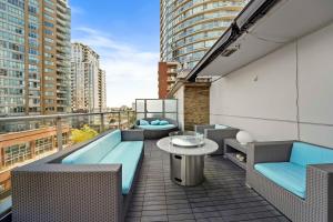 a balcony with chairs and a table on a building at The Vancouver Penthouse, 2-Level, Patios, Hot Tub in Vancouver