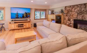 a living room with a couch and a large screen tv at The Meadows - Ski Lease - Extended 30 Plus Days in South Lake Tahoe
