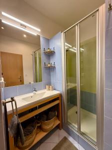 a bathroom with a sink and a shower at CityStay Apartment Žilina with Parking in Žilina +9 photos