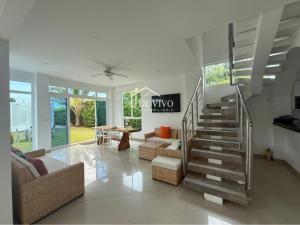 a living room with a staircase in a house at VILLA MANDALAY in Santa Veronica