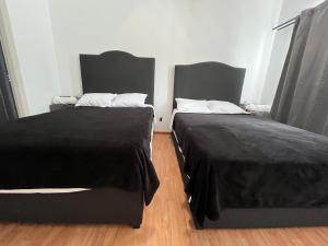 two beds sitting next to each other in a room at 23 Habitación doble cama in Miravalle