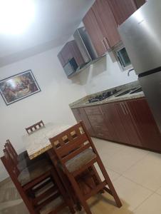 a kitchen with a table and two chairs and a counter at Casa in Mazatlán