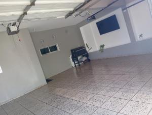 an empty room with white walls and a tile floor at Casa in Mazatlán
