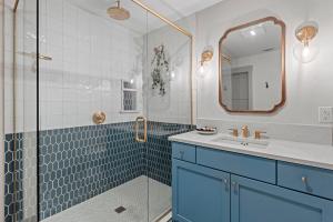 Un baño con ducha, lavabo y espejo. en The Smith Haus - Sleeps 12 Pool Game Room, en Fredericksburg