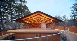 a building with a wooden roof on a deck at SHISHI-IWA HOUSE Karuizawa in Karuizawa