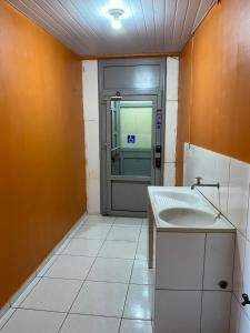 a bathroom with a door and a sink in it at Pousada ExtraLar in Fortaleza +41 photos
