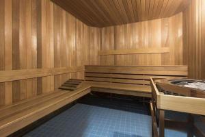 an empty sauna with a tub in a room at Cozy Condo in the heart of the city in Vancouver +9 photos