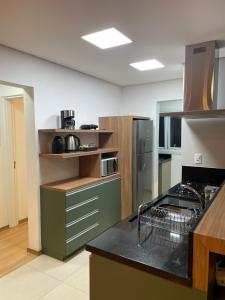 a kitchen with a sink and a counter top at Apartamento Bolognese in Canela