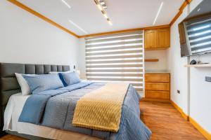 En eller flere senge i et værelse på Moderna Casa Cuenca