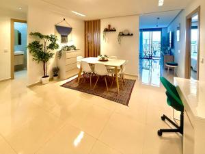 a kitchen and dining room with a table and chairs at Sunny 3 bedrooms Apartment - balcony and workspace in Kenitra