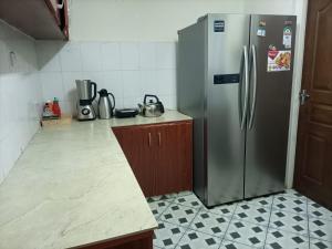 a kitchen with a stainless steel refrigerator at SarafuDeluxe in Nakuru